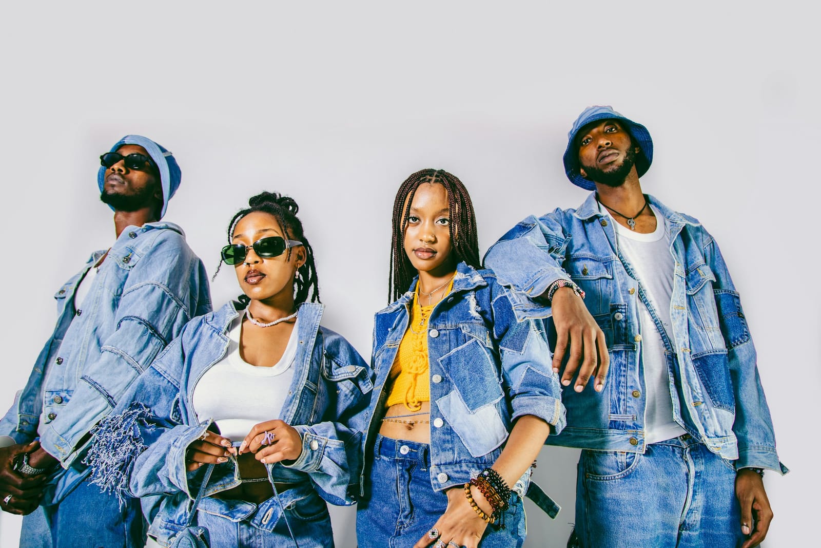 A group of friends in denim, posing together.
