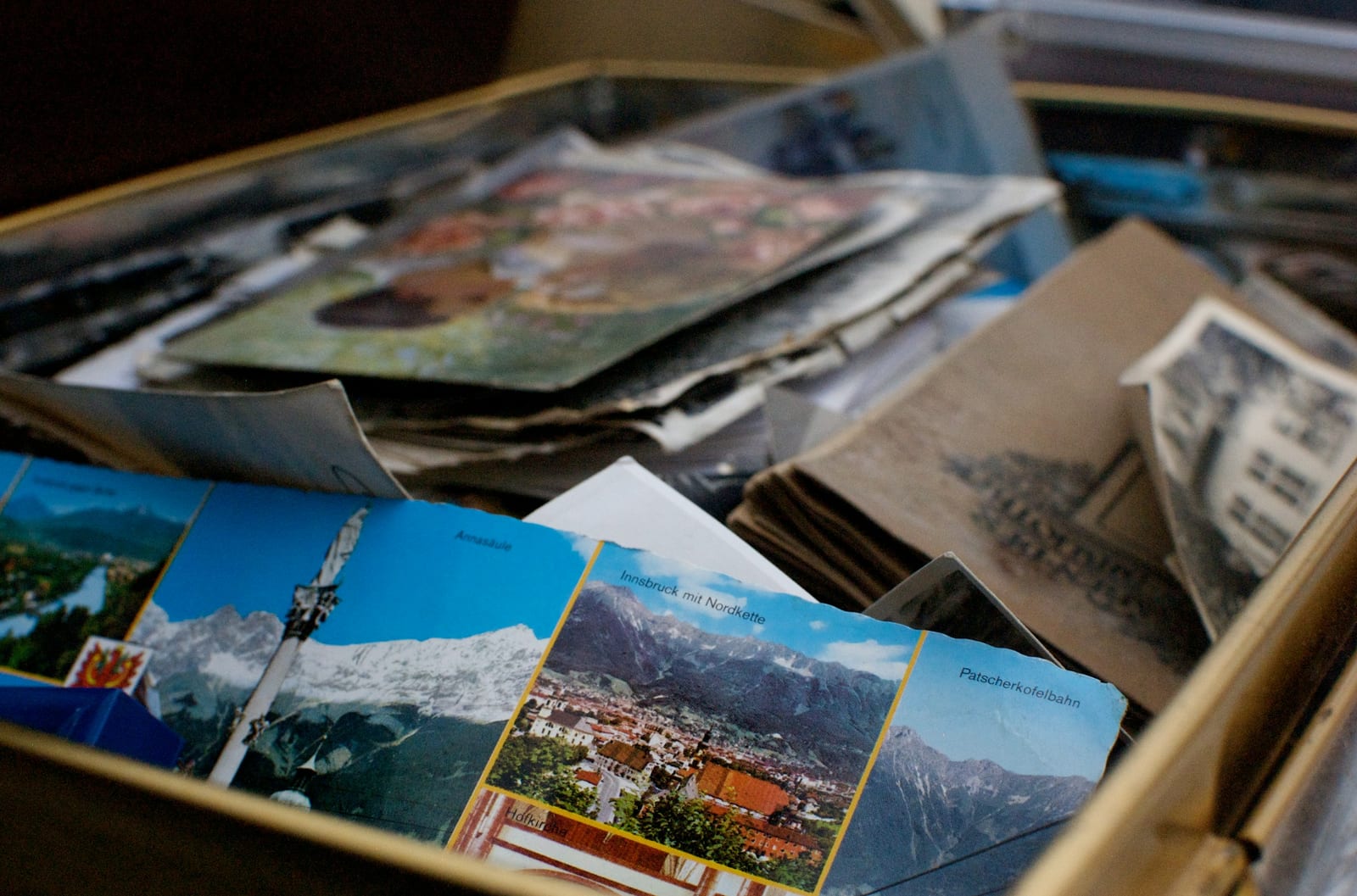 A box of old photographs and postcards of places.